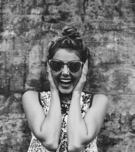 Girl in good mood wearing sunglasses and laughing