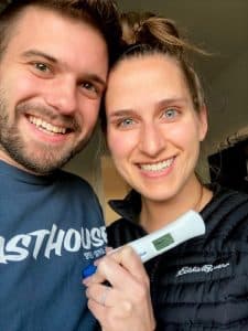 happy couple holding positive pregnancy test