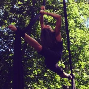 Heather performing aerial work in the woods
